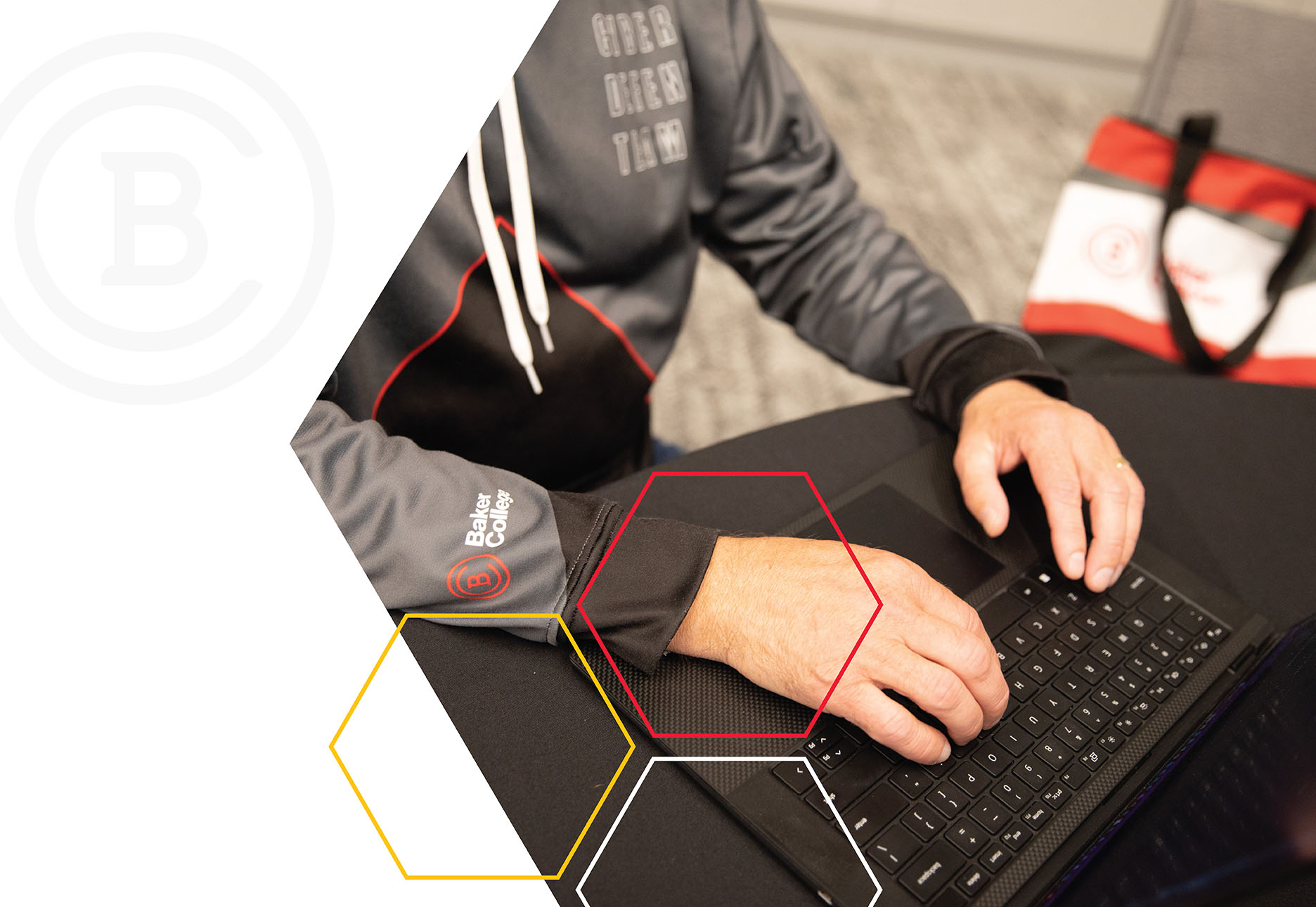 A student sits at a computer in a computer lab.