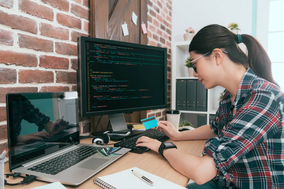 Woman business computer engineer using coding data developing protecting credit card personal information system.